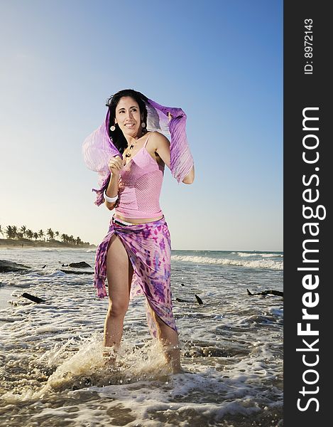 Portrait of young trendy fashion woman posing by the ocean. Portrait of young trendy fashion woman posing by the ocean