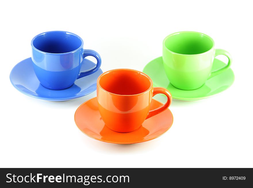 Three colored cups, isolated over white board. Three colored cups, isolated over white board