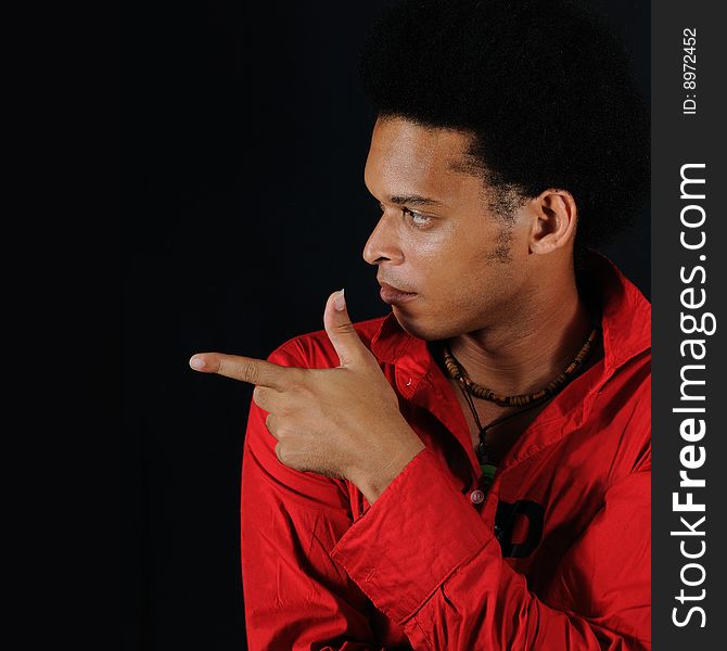 Portrait of young african man pointing finger - isolated on black