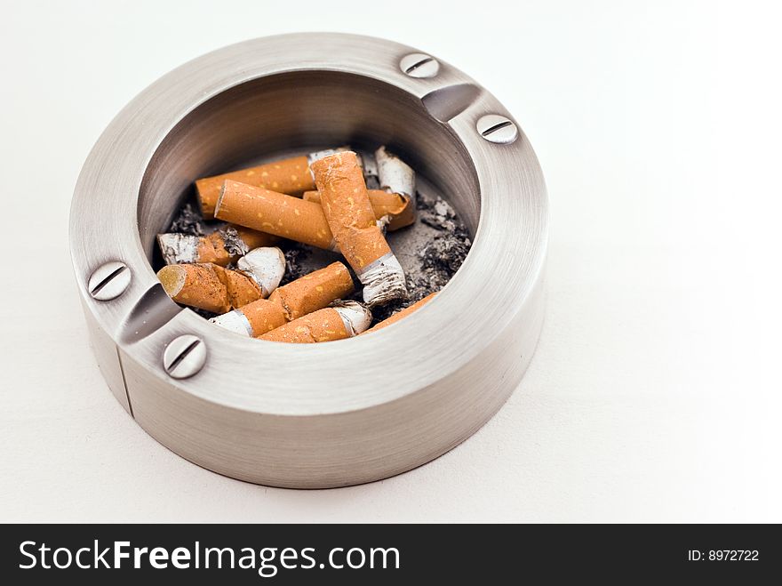 Metallic ashtray with cigarette butts. Metallic ashtray with cigarette butts