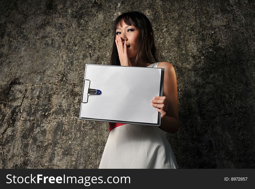 Beautiful Asian woman showing paper on clipboard and facial expression.