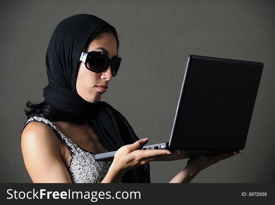 Portrait of classy woman with sunglasses holding laptop. Portrait of classy woman with sunglasses holding laptop