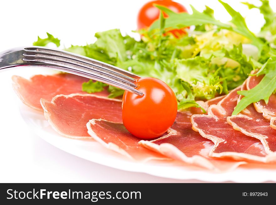 Gammon with salad and cherry tomatoes on the plate