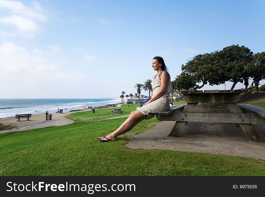 Caucasian woman relax on the california beach over green grass. Caucasian woman relax on the california beach over green grass
