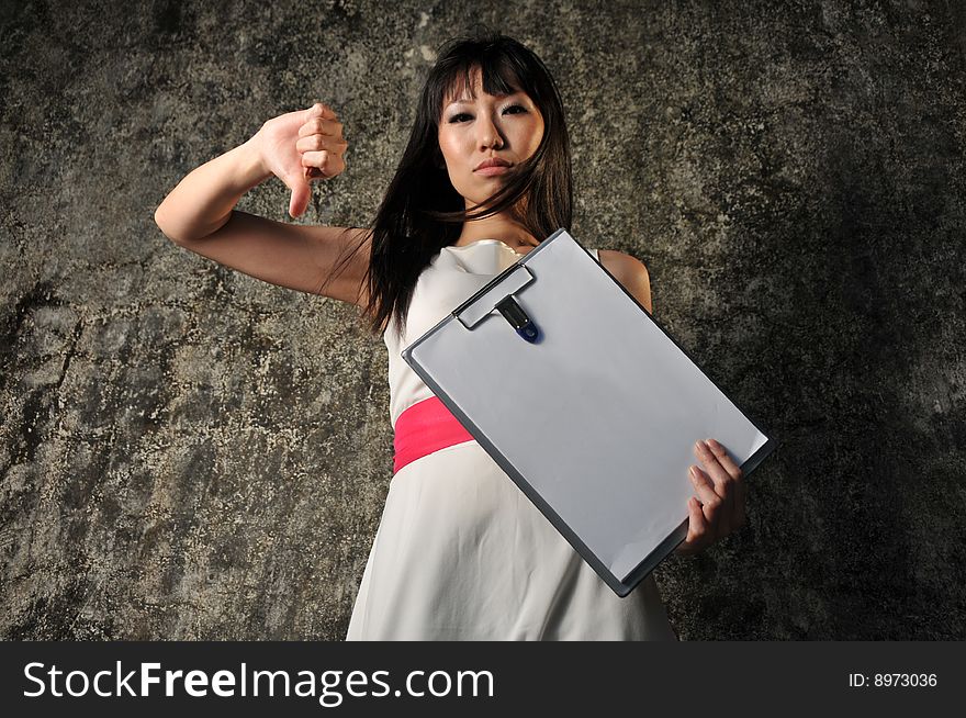 Beautiful Asian woman holding an empty clipboard and hand sign. Beautiful Asian woman holding an empty clipboard and hand sign.