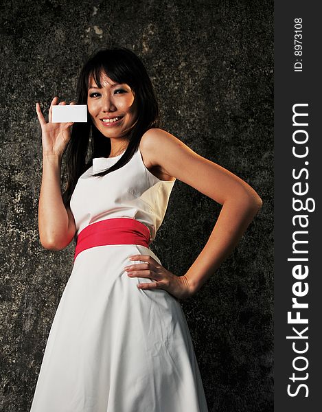 Beautiful modern Asian woman showing her name card. Beautiful modern Asian woman showing her name card.