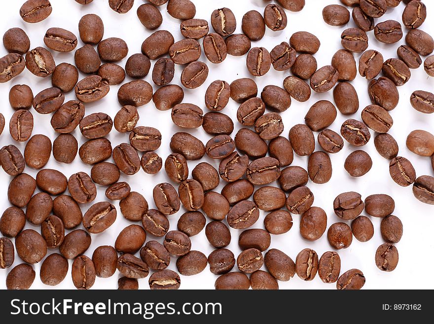 Coffee beans over white background