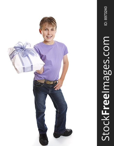 A young boy dressed in jeans and t-shirt holds a present tied up with a big ribbon ow. A young boy dressed in jeans and t-shirt holds a present tied up with a big ribbon ow.