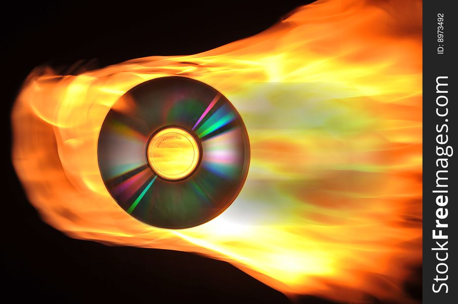 Burning CD and fire on black background