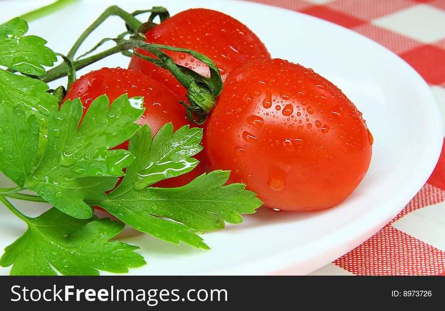 Tomato and parsley ready to eat in the plate. Tomato and parsley ready to eat in the plate