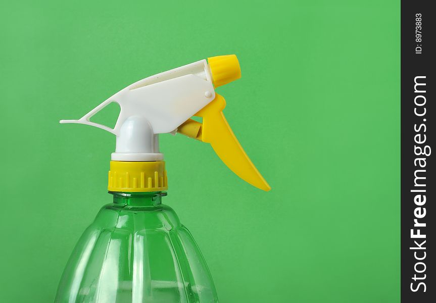 Watering can in the green background. Watering can in the green background