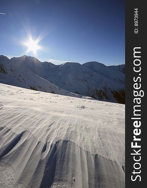 Sun on clear sky over the top of the Fagaras Mountains. Sun on clear sky over the top of the Fagaras Mountains.