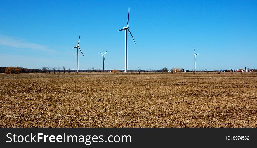 An image of a farm of wind turbines. An image of a farm of wind turbines.