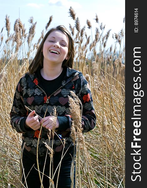 Young Girl Laughing In Field