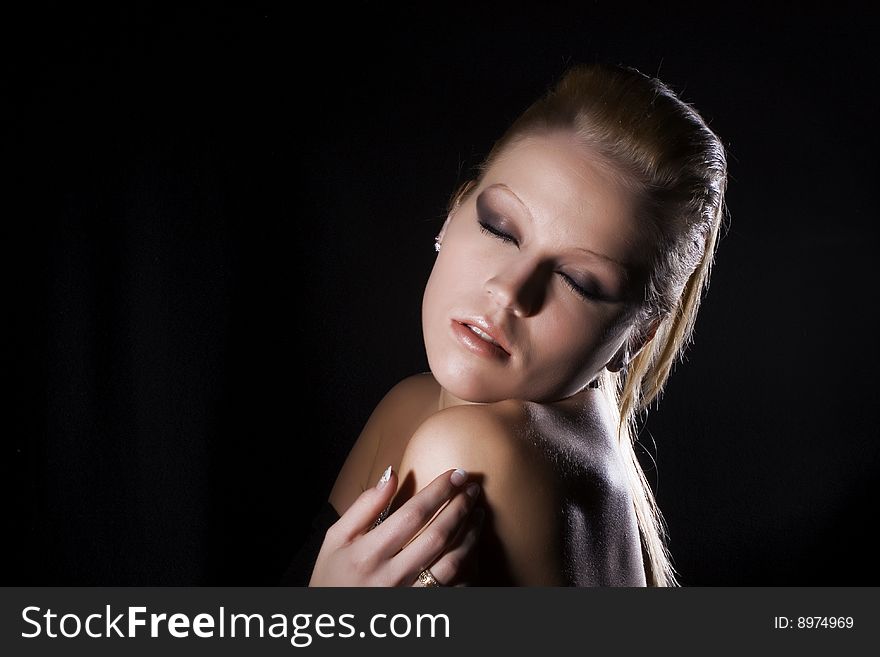 Closeup of Beautiful blond girl on a black background. Closeup of Beautiful blond girl on a black background