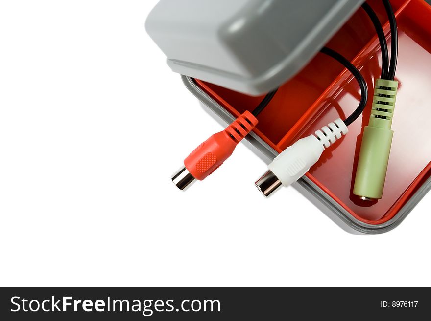 New and clean plastic tool box with audio cable plugs inside isolated on white. New and clean plastic tool box with audio cable plugs inside isolated on white