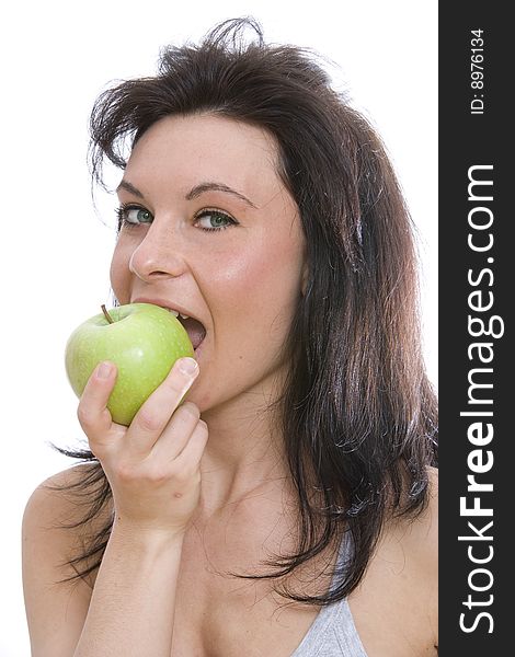 Young caucasian brunette eating a green apple isolated on white. Young caucasian brunette eating a green apple isolated on white