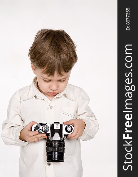 Attractive little boy with photo camera over white. Attractive little boy with photo camera over white