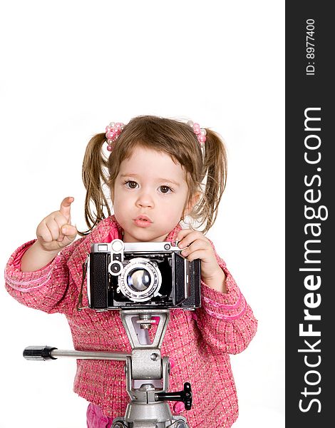 Attractive little girl with photo camera over white. Attractive little girl with photo camera over white