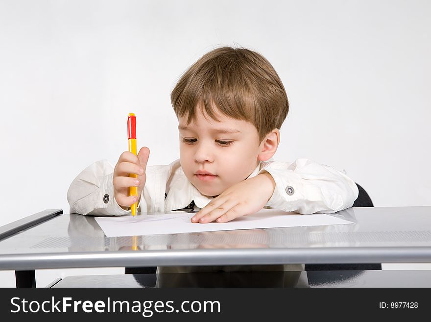 Adorable little boy with pencil