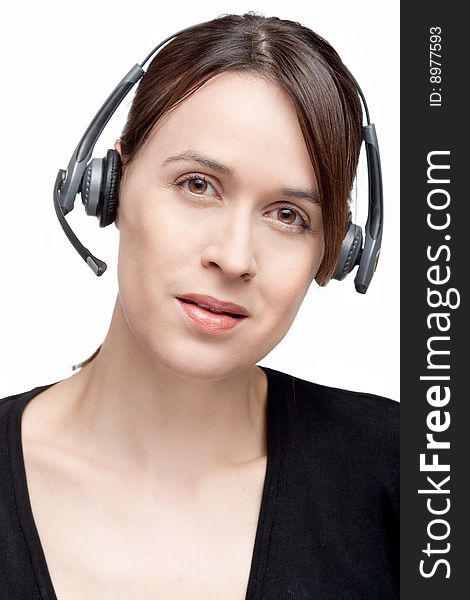 A woman with a headset communications gear on white. A woman with a headset communications gear on white.