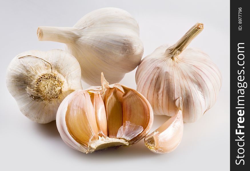 Three cloves of garlic on the white background