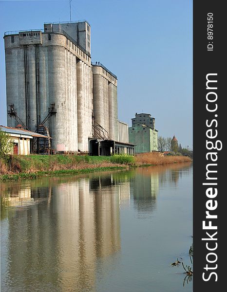 A view with a concrete silo reflected in. A view with a concrete silo reflected in