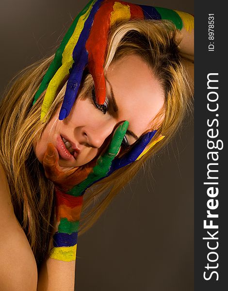 Pretty female model with hands painted rainbow style. Pretty female model with hands painted rainbow style