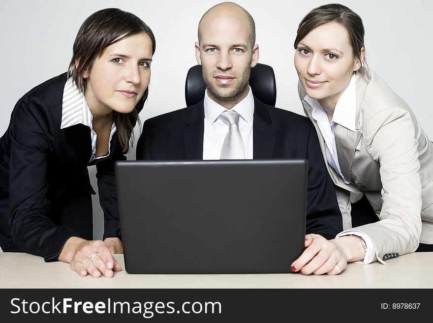 Young businessteam of three persons in office