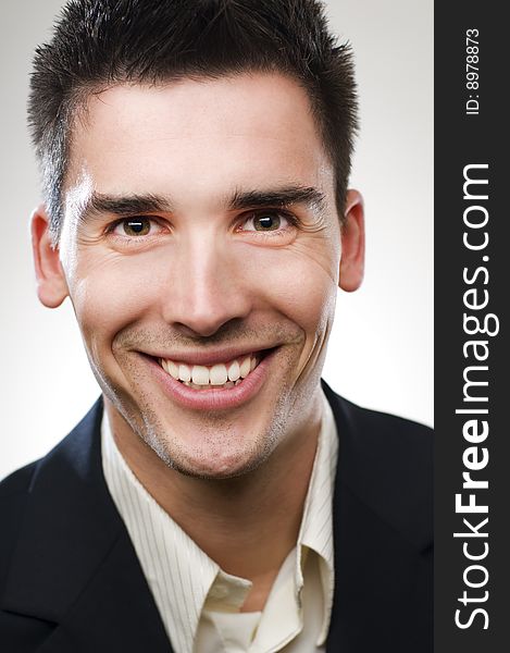 Cheerful young businessman close up portrait