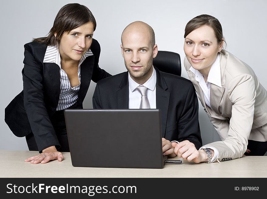 Young businessteam of three persons in office