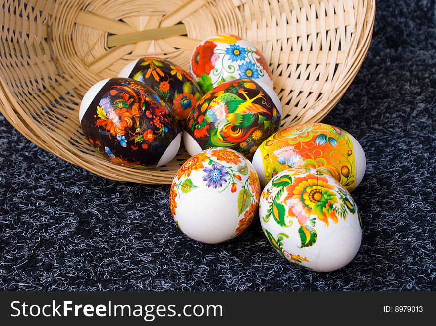 Easter painting eggs lie near inverted, wattled small baskets. Easter painting eggs lie near inverted, wattled small baskets