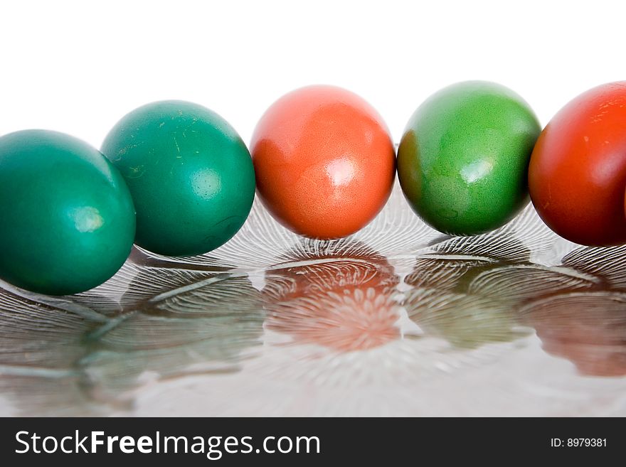 Five colored eggs on a transpearent dish. Five colored eggs on a transpearent dish