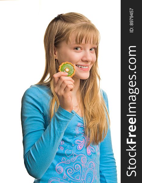 Young blonde girl with biscuit near her mouth. Young blonde girl with biscuit near her mouth