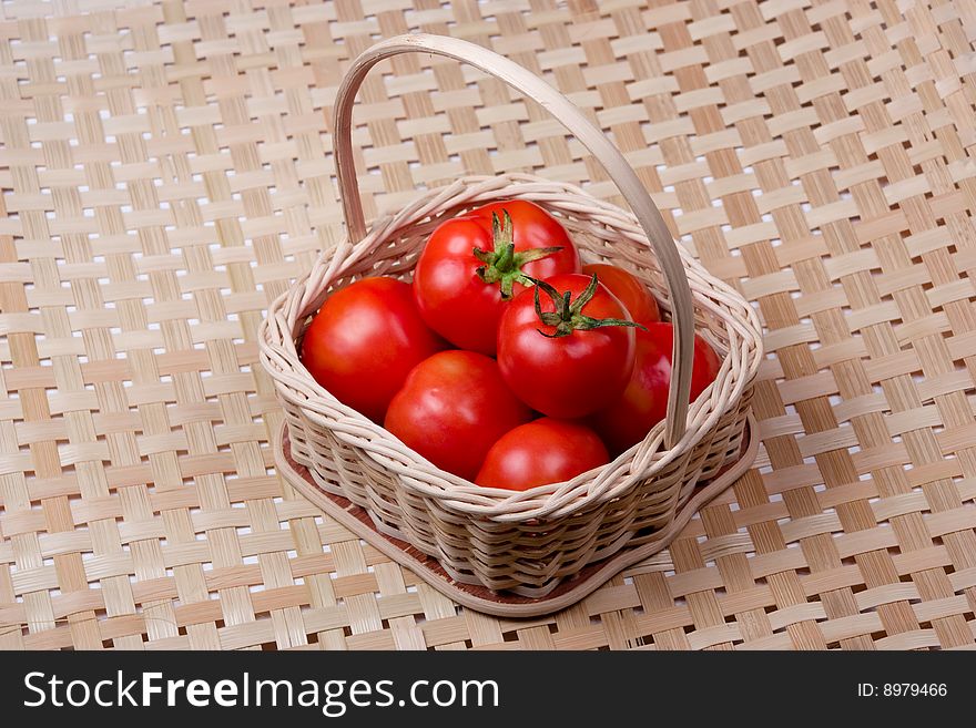 Tomato basket with bamboo mat background