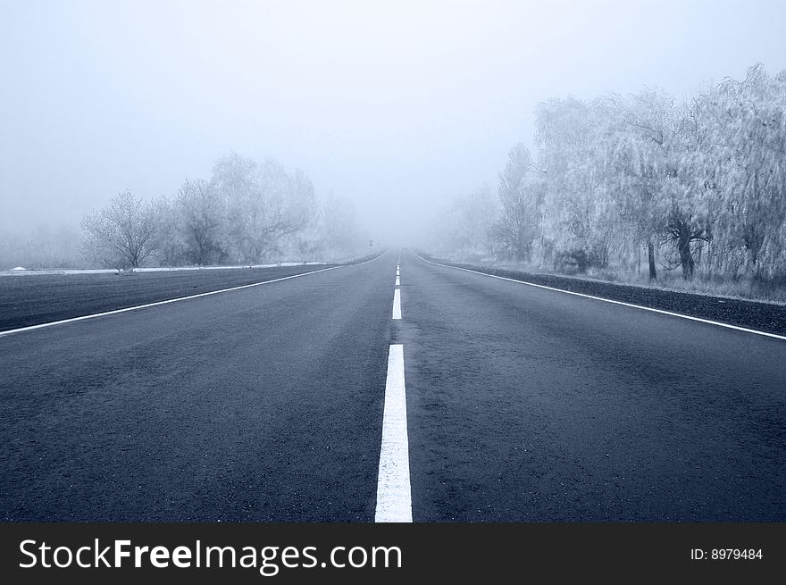 Empty road to a fog. Monochrome