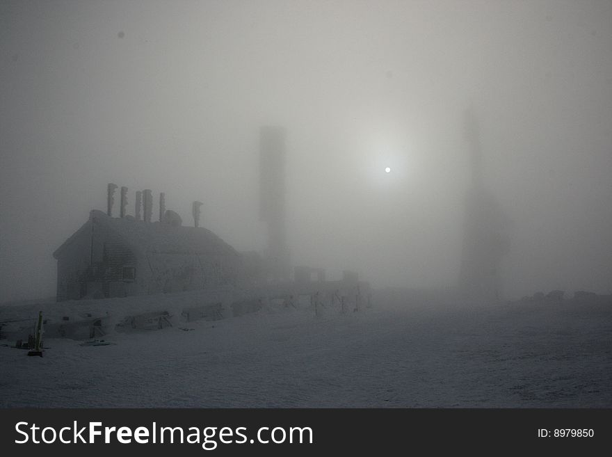 Rime ice covered stage office and antenna of mount washington in fog with special effects. Rime ice covered stage office and antenna of mount washington in fog with special effects