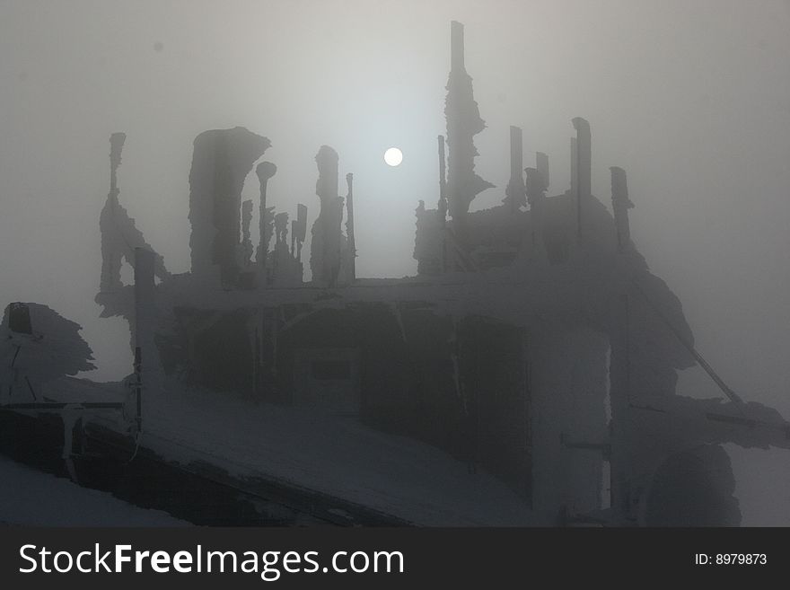 Rime ice covered building in fog