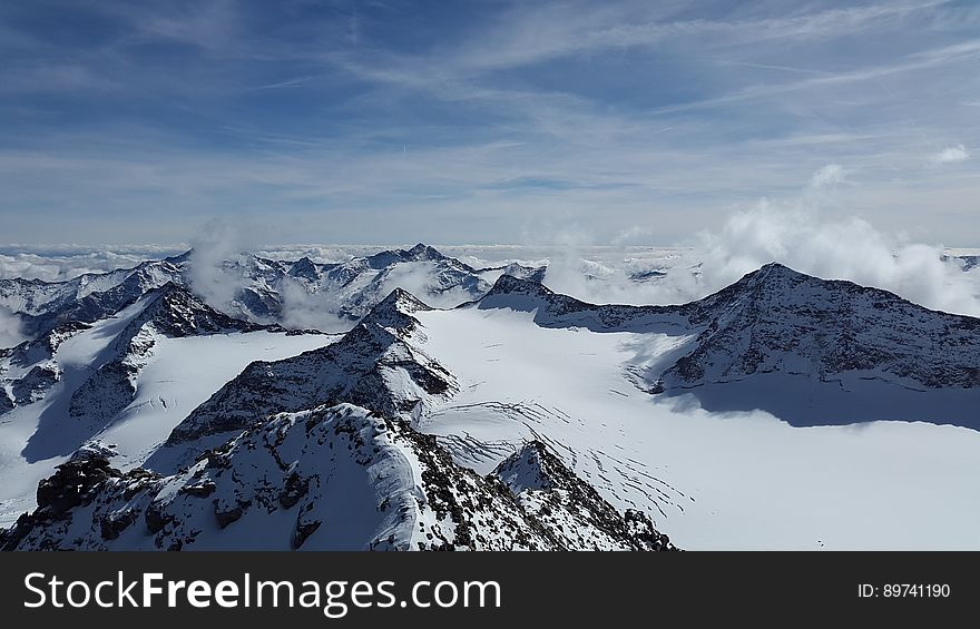 A view over snowy mountain peaks. A view over snowy mountain peaks.