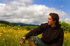 Young Man On Yellow Meadow In Sunny Weather Royalty Free Stock Photography Young Man On Yellow Meadow In Sunny Weather Royalty Free Stock Photography