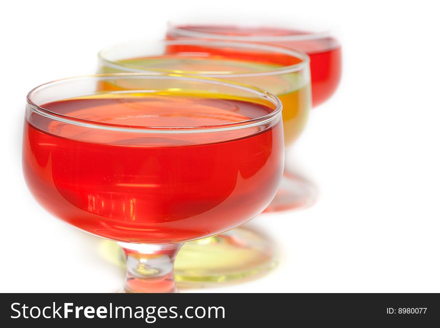 Yellow, red jelly in transparent glass stand on white background inline. Yellow, red jelly in transparent glass stand on white background inline