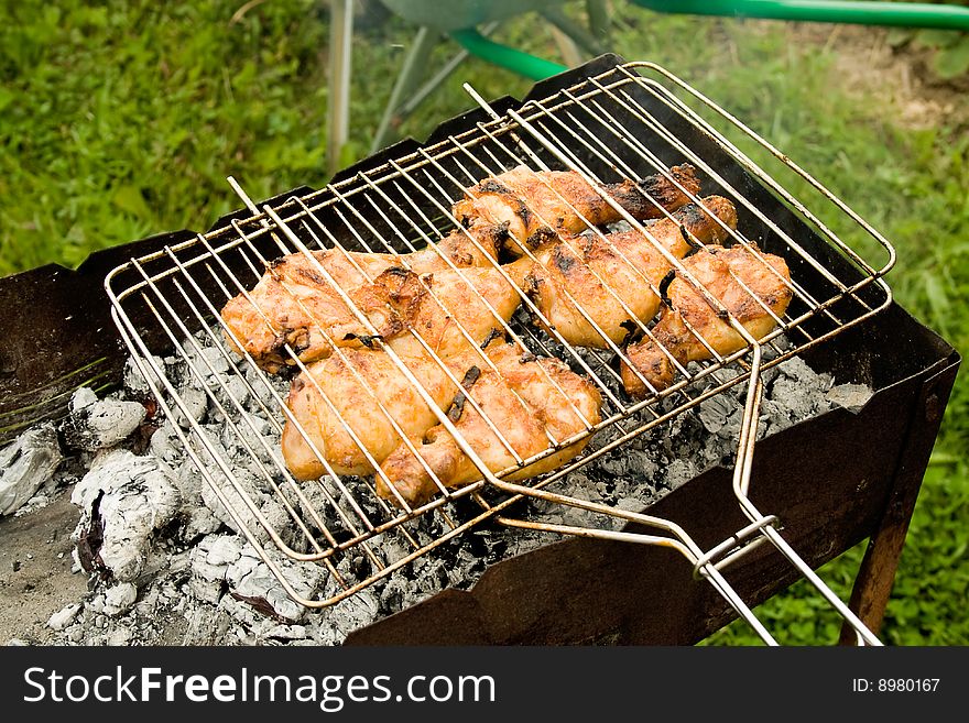 Juicy chicken grill on hot coals