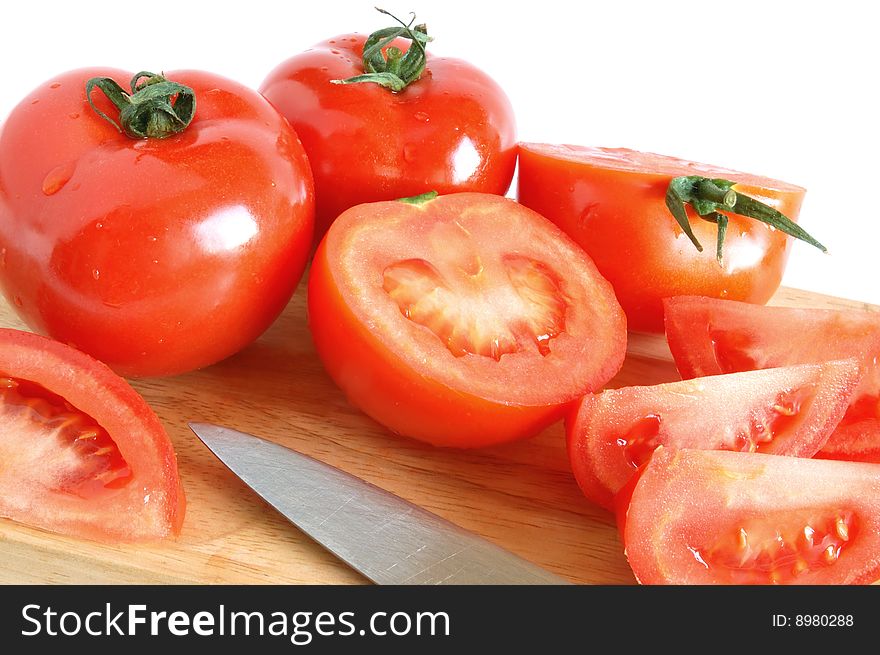 Fresh tomatoes on wooden background