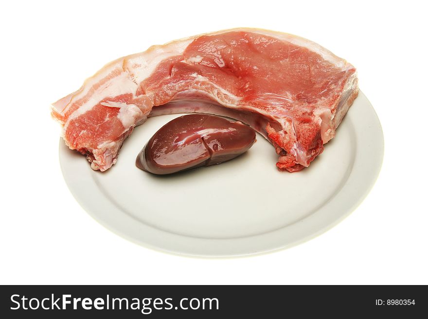Pork chop and pigs liver on a plate. Pork chop and pigs liver on a plate
