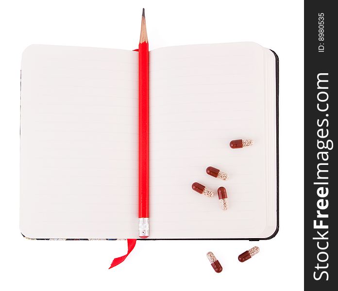 Open diary with pencil and pills isolated. Open diary with pencil and pills isolated