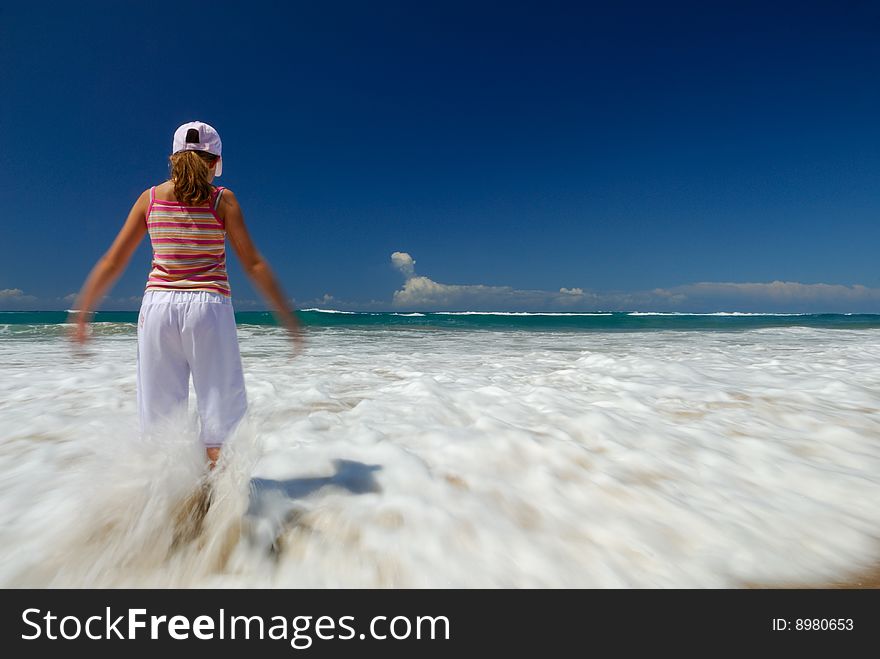 Girl enjoying waves on the beach. Girl enjoying waves on the beach