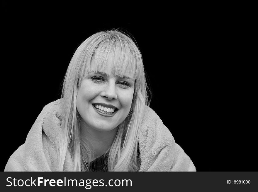 Portrait of a Beautiful Blond Woman Smiling against a Black Background. Portrait of a Beautiful Blond Woman Smiling against a Black Background