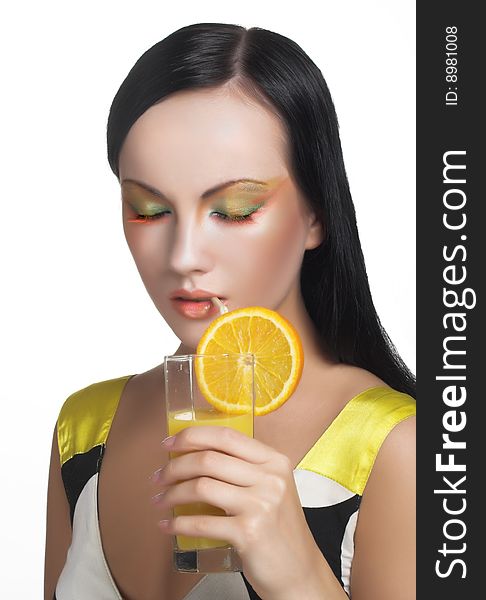 Romantic portrait of young charming lady with a glass of orange juice. Romantic portrait of young charming lady with a glass of orange juice.