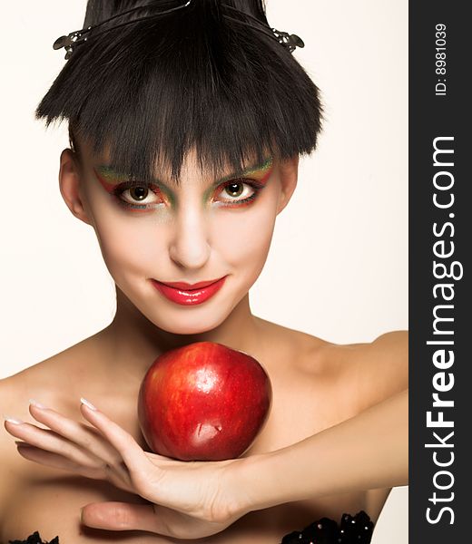 Portrait of pretty brunette with red apple. Portrait of pretty brunette with red apple