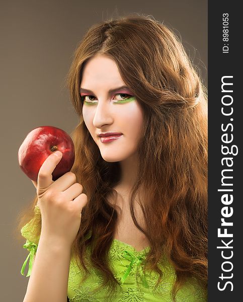 Portrait of young girl witn fresh red apple in her hand. Portrait of young girl witn fresh red apple in her hand